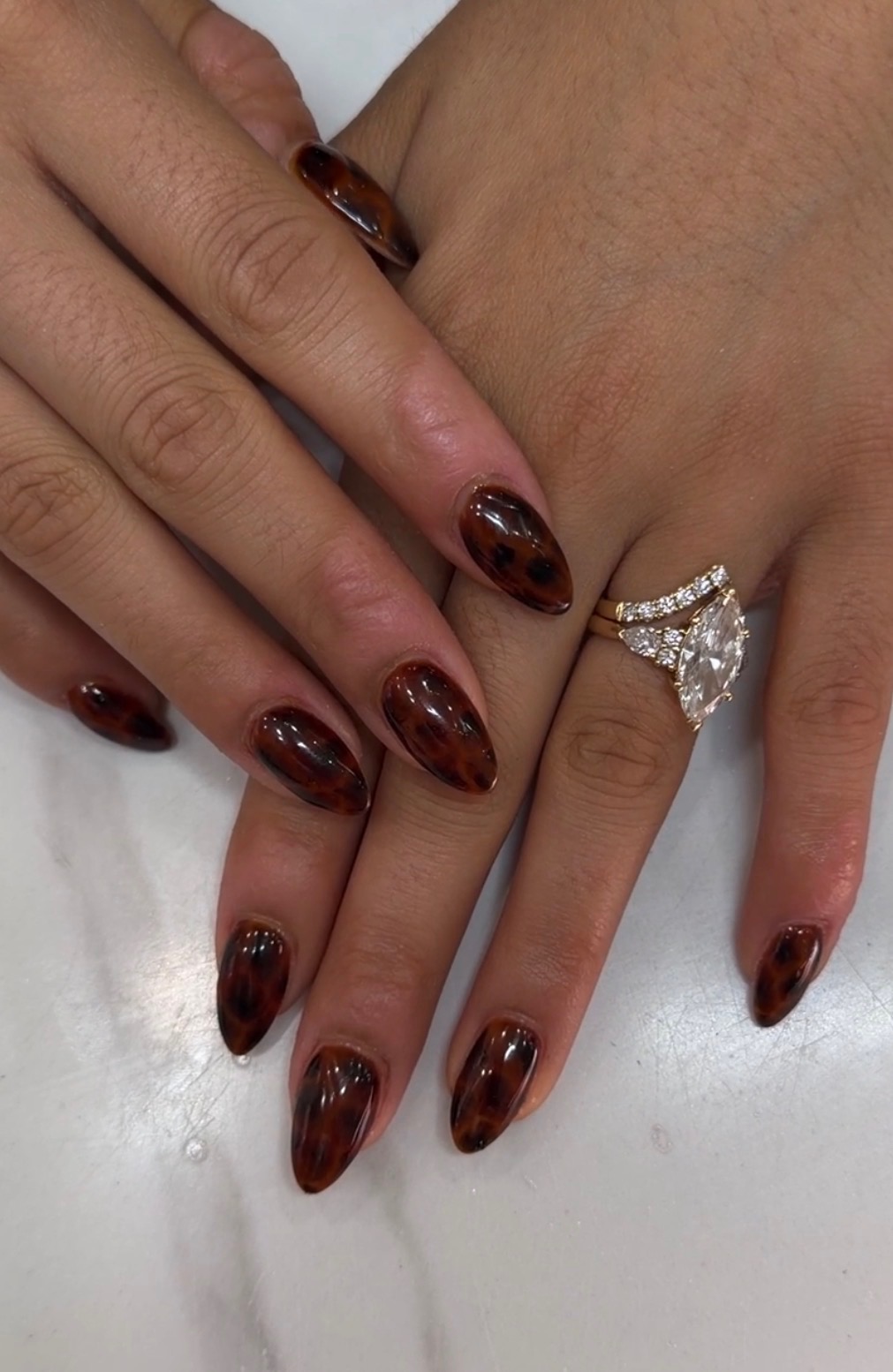 Salon tortoise shell almond manicure with diamond ring